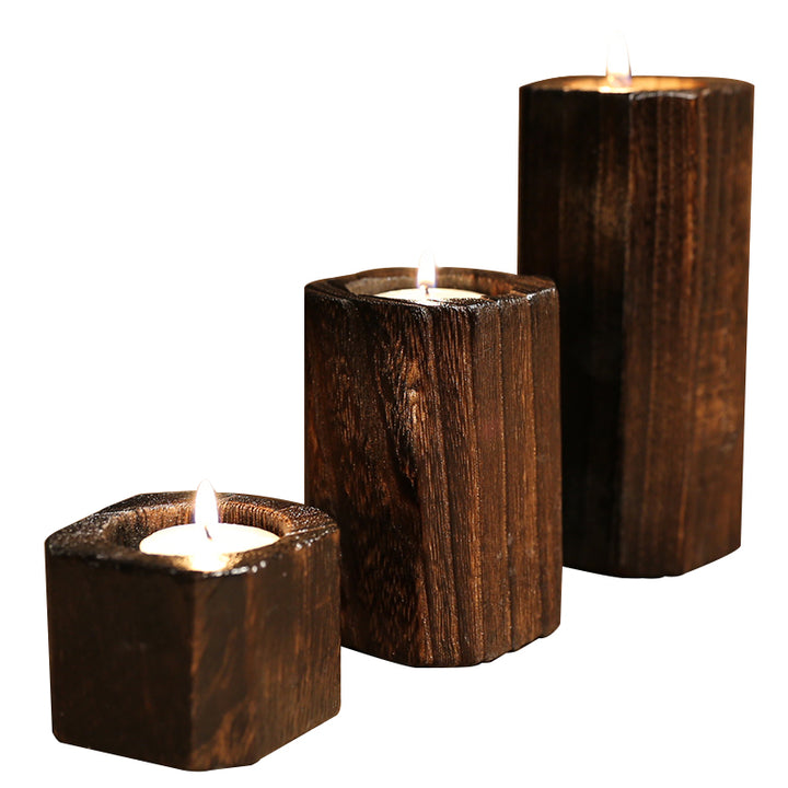 Three charred wood candle holders, small, medium and large, on white